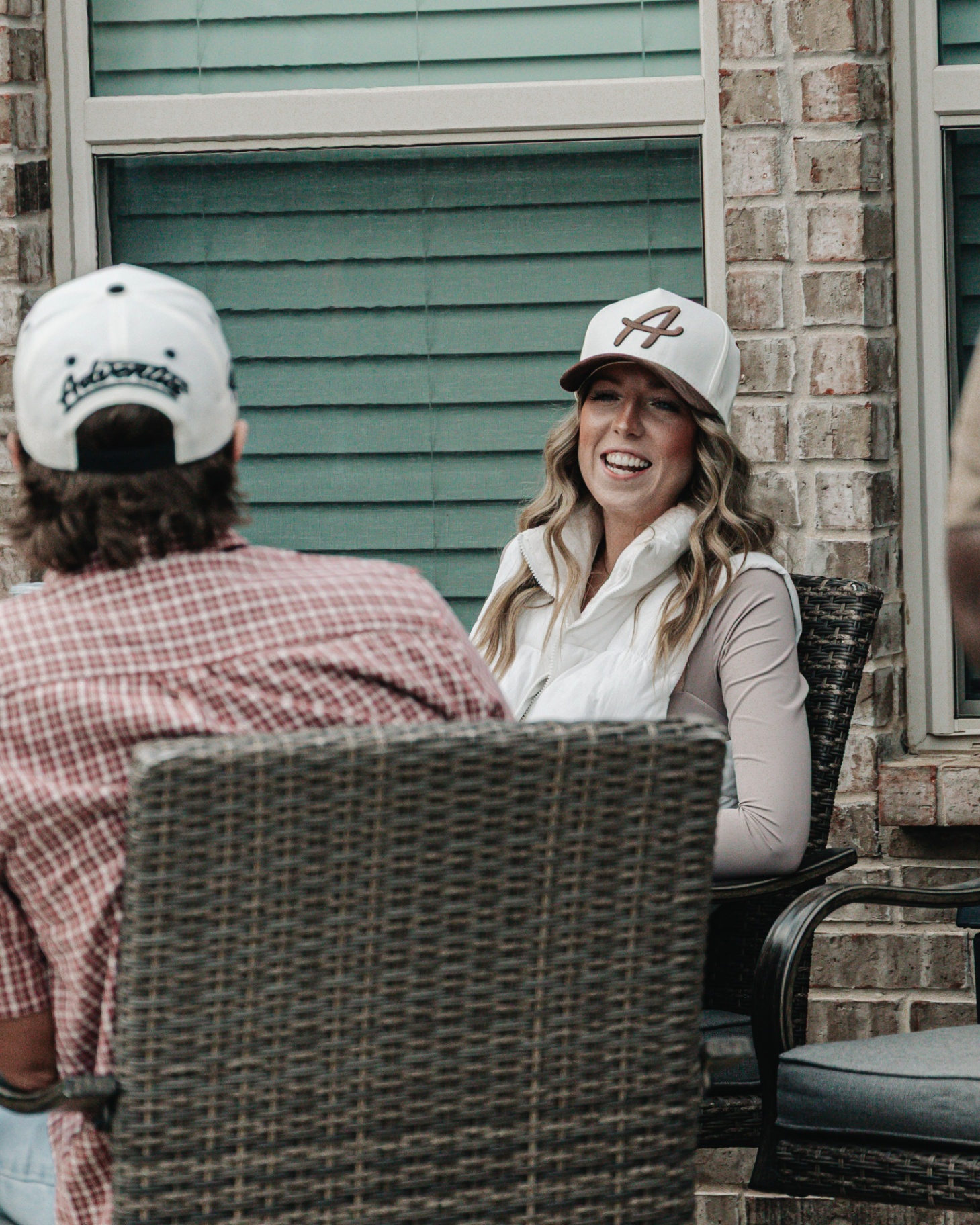 Adventus lifestyle — friends on the porch in Adventus caps